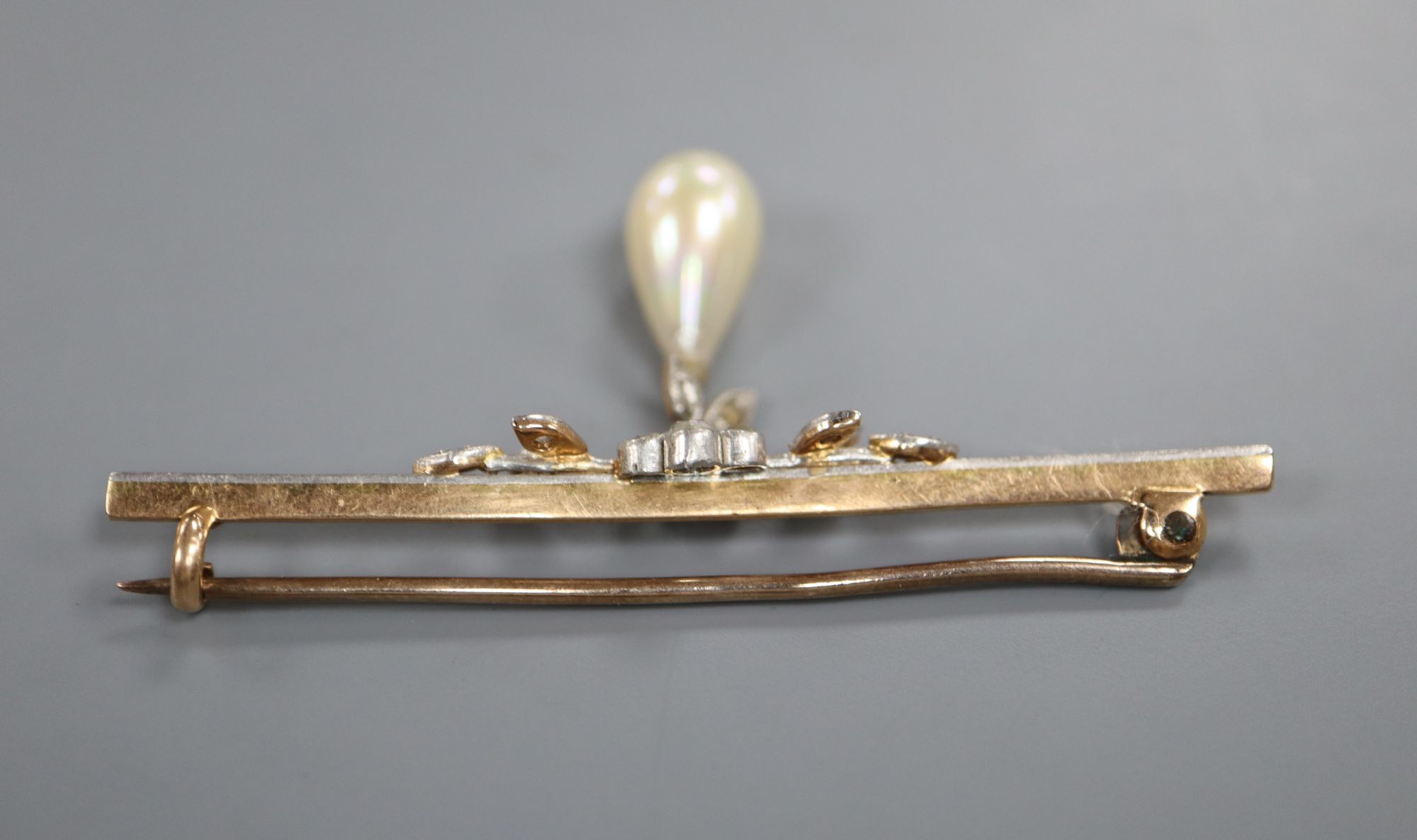 A 1920s yellow metal, rose cut diamond and simulated pearl drop set bar brooch, 52mm, gross 3.6 grams.
